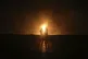 Two men look at flames after a natural gas pipeline explodes