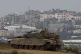 An Israeli soldier on top a tank on the border with the Gaza