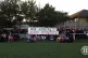 Clapton CFC players, staff and fans unfurl a banner to Max L