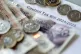 Money stacked on top of a council tax bill