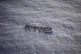 A photograph taken from the air of a sinking refugee dinghy 
