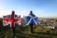 Scottish and British flags held up over Edinburgh