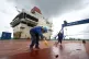 A painter paints the deck of an aircraft carrier in June 201