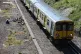A Merseyrail train passes along track at Hunts Cross station