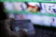 A laptop user holding a bank card whilst browsing a porn sit