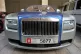 A blue and silver Rolls Royce with a United Arab Emirates nu