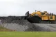 A digger tears up the ground near the site of Hinkley Point 