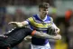 Castleford Tigers' Jamie Ellis (left) tackles Leeds Rhinos' 