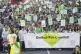 People take part in a silent walk by Grenfell Tower, to mark