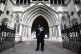 A demonstrator outside the Royal Courts of Justice, London, 