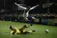 Guiseley's Niall Heaton and Fleetwood Town's Lewie Coyle bat