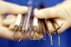 A dental nurse holds dental instruments.