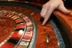 A croupier with a roulette table