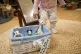 A child takes out a toy from a 'bite box' at the Tops Day Nu