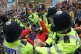Police arrest a protester at Millbank near to the junction w