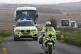 Passengers in coaches leave MoD Boscombe Down in Wiltshire a
