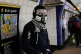 A person wearing a full face mask in King's Cross undergroun