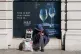 A homeless man sits outside a Marks and Spencer in Mayfair, 