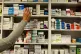 A pharmacist stocking shelves at a chemist
