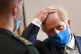 Prime Minister Boris Johnson, wearing a face mask, talks wit