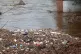 The River Calder filled with branches and rubbish flows thro