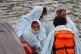 A group of people thought to be migrants are brought into Do