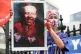 A protester holds an image dipicting Tory health secretary M