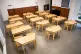 Tables and chairs spaced for social distancing in a classroo