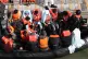 A group of people, thought to be migrants, waiting on a Bord