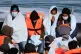 A group of people thought to be migrants are brought into Do
