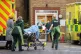 Paramedics transfer a patient from an ambulance into Southen