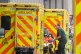 Paramedics unload a patient from an ambulance outside the Ro