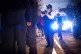 A female police officer uses her radio during a stop and sea