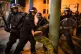 Police officers detain a man as they move in on demonstrator