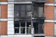 Firefighters inspect damage to a 19-storey tower block in Ne