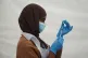 An NHS worker prepares a Covid jab at a pop-up vaccination c