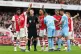 DISPUTE: Referee Stuart Attwell surrounded by Arsenal player