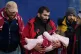 A man carries a small child after they were brought in to Do