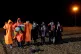 A group of people walk across the beach in Dungeness, Kent, 