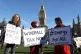 People in Parliament Square, London, take part in the People