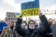 People take part in a demonstration outside the Russian Cons