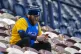 A Preston North End fan looks at his phone while sitting in 