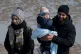 A young child is carried amongst a group of people after bei