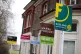 A row of letting agent signs placed outside houses