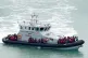 A group of people are brought in to Dover, Kent, as more tha