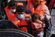 A group of people, including a child, are brought in to Dove