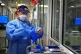  File photo dated 21/12/2021 of a nurse puts on PPE in a war