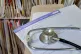 A registration form and a stethoscope at GP surgery