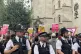 Police officers look on as demonstrators outside the Royal C