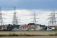 A view of electricity pylons behind houses in Lydd, Septembe